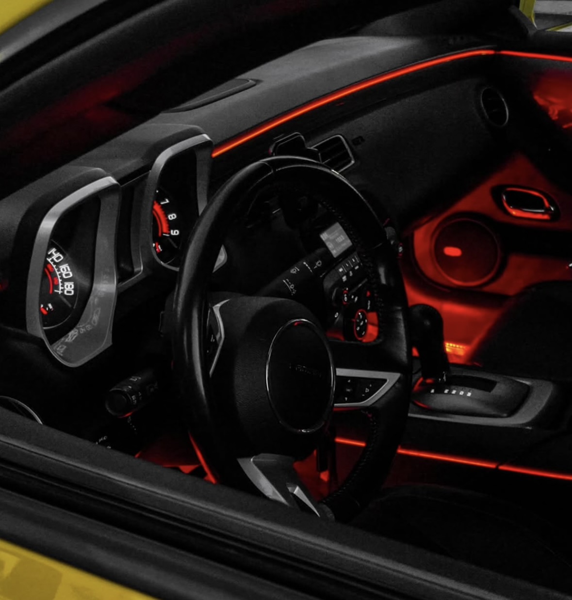 Red automotive ambient lighting viewed from the driver side