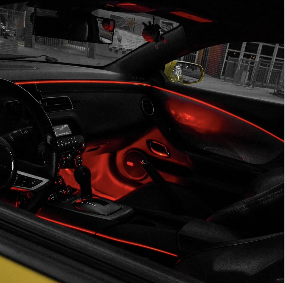 Red automotive ambient lighting viewed from the passenger side